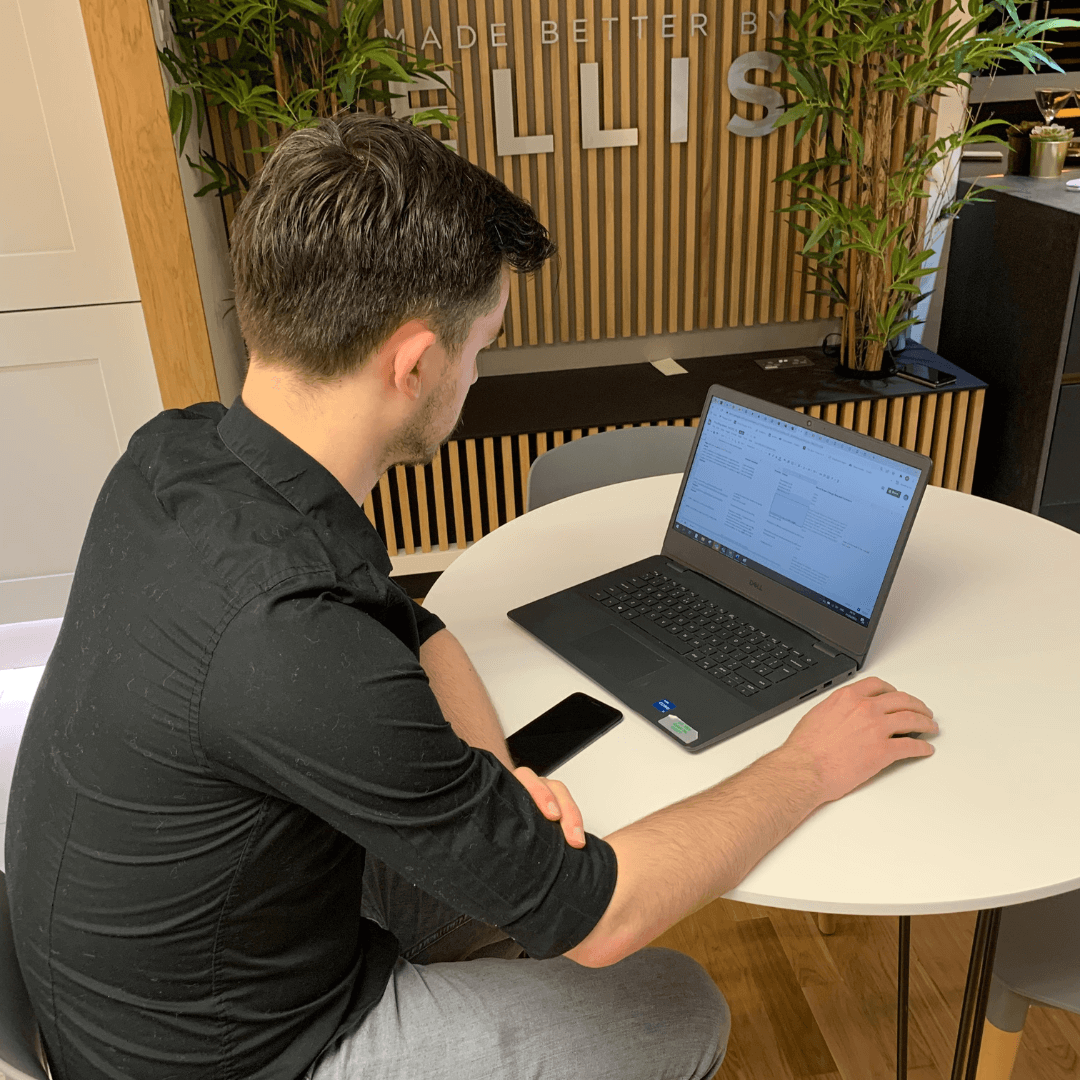 Man-on-Laptop-Looking-at-Spreadsheet-(1)